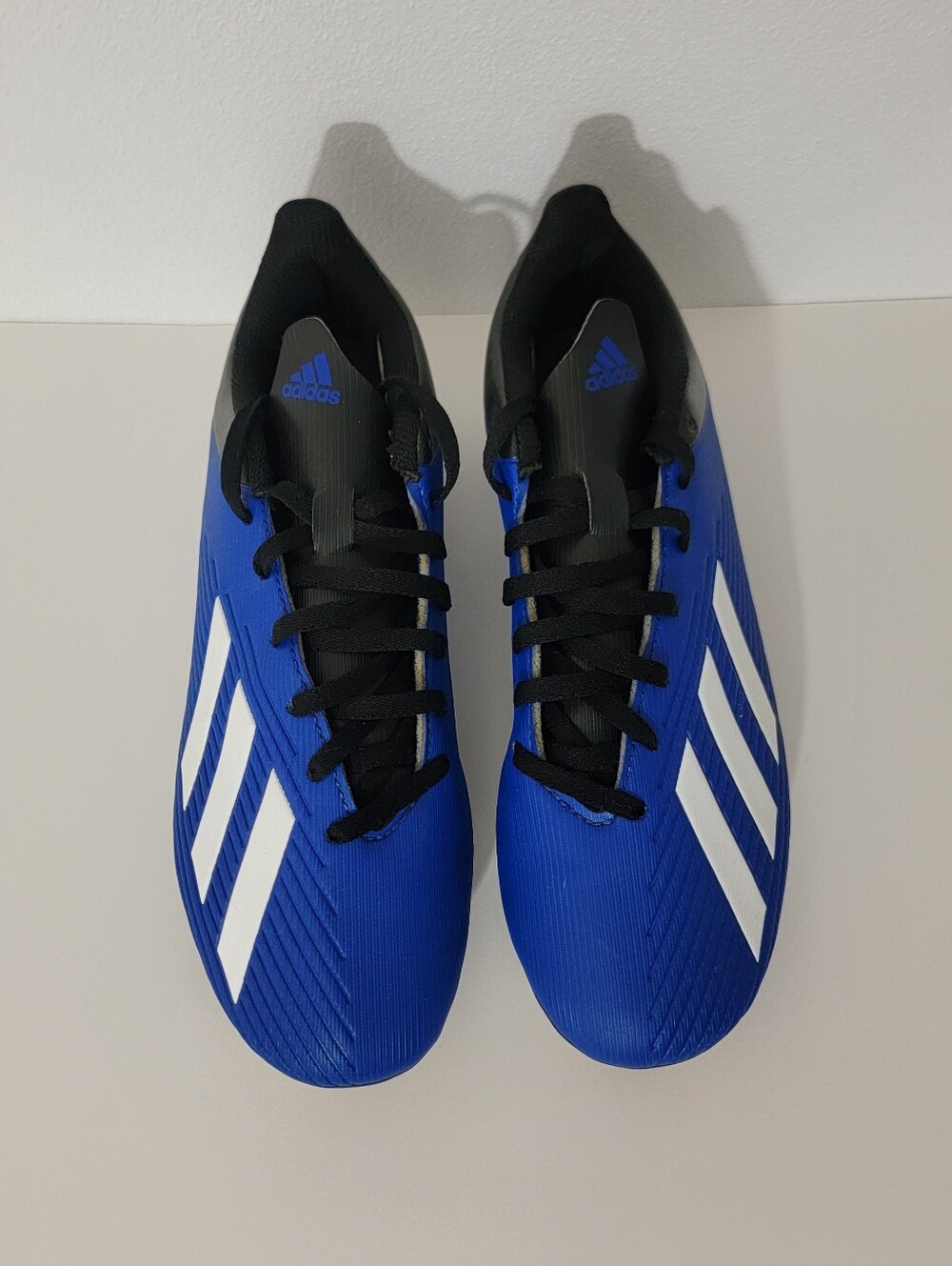 Adidas X 19.4 FxG soccer cleats in Team Royal Blue with white three-stripe brand